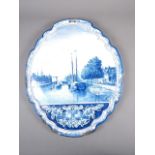 A Delft blue and white shaped wall plaque with boats in a river decoration, 19 3/4" high x 16 1/2"