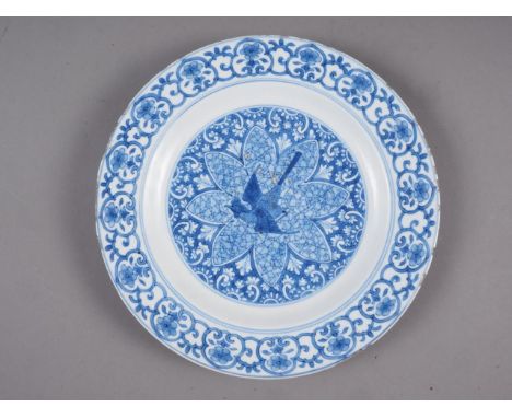 A Chinese blue and white plate with central bird, flower and scroll decoration and floral spray inside, double ring mark to b