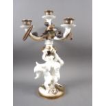 A 19th century Moores three-branch four-light candelabrum of cherub and floral design with gilt