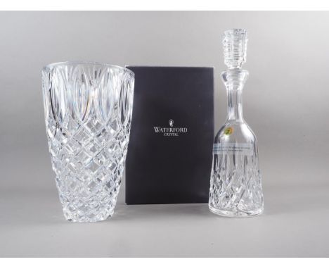 A Waterford Crystal "Lismore" pattern decanter and stopper, and a Waterford Crystal "Grant" pattern vase, 10" high, both in o