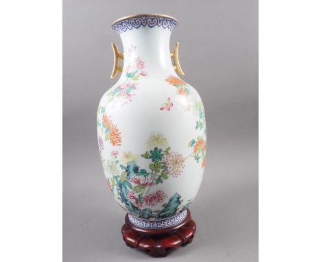 A Chinese Republic baluster vase with gilt handles and floral, rock and verse decoration, seal mark to base, 13" high, on har