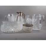 A silver plate mounted claret jug, a silver rimmed bowl, an Edinburgh crystal bowl, another similar,