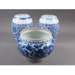 A pair of Chinese blue and white drum-shaped vases and covers with scroll and flower decoration,