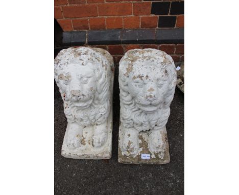 A pair of part painted cast concrete garden lions 