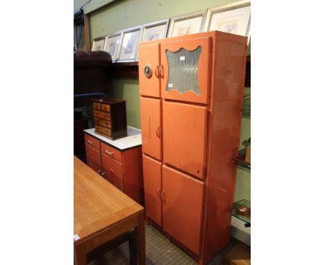 An orange finished two-piece retro kitchen/larder suite comprising freestanding multi-cupboard fronted unit and enamel, food 