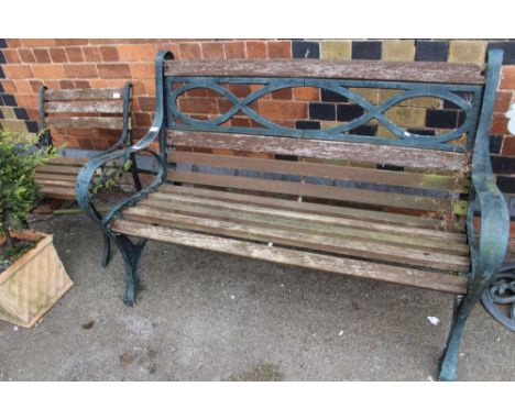 A verdigris patinated metal and teak slatted garden bench, and similar chair 