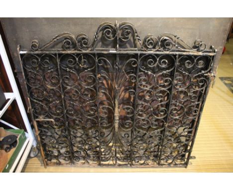 A pair of black finished wrought metal garden gates 