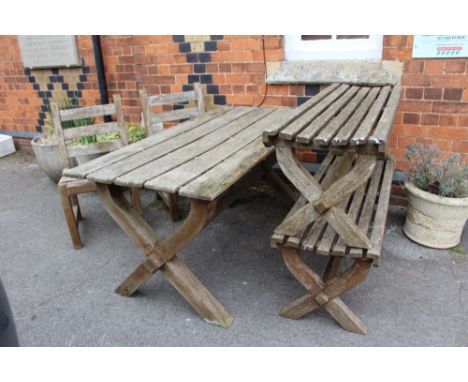 A teak plank topped garden trestle table, together with a pair of matching benches, and two single chairs 