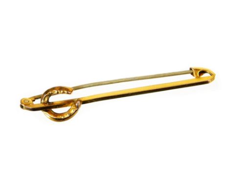 A horseshoe type pin, with plain stick surmounted by a horseshoe, with plain pin back, marked 9ct, 5cm wide, 1.5g all in.