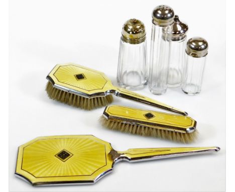 A chrome plated and yellow enamel dressing table set, to include hand mirror 31cm wide, clothes brush and hair brush, sifter 