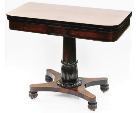 An early 19thC rosewood card table, the rounded top raised on a heavy gun barrel and floral column, terminating in an inverte