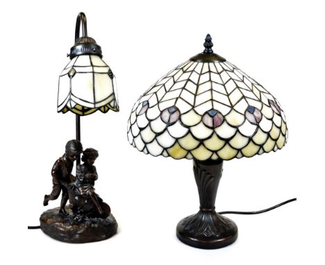 A Tiffany style lamp, with shaped shade predominantly in white and blue, 46cm high, and a further table lamp with similar sha