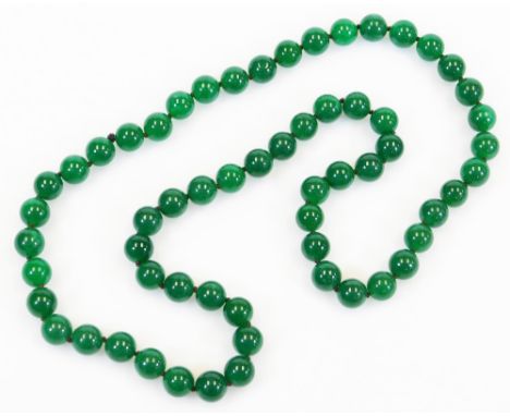 A string of modern jade style beads, on brown string, with single knot divide, each bead 1.5cm wide, 174g all in, 88cm long o