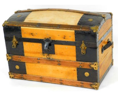 A 20thC dome top trunk, with wooden banding and metal mounts with leather side handles, 49cm high, 72cm wide, 46cm deep. 