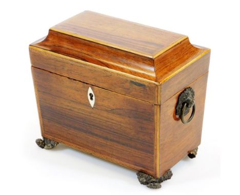 A Regency rosewood tea caddy, of rectangular form with ivory escutcheon, part fitted interior, heavy metal handles on shaped 