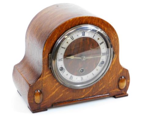 A mid 20thC oak cased chiming mantel clock, 12cm diameter Roman numeric dial, in carved oak case striking on four gongs, 23cm