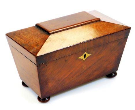 An early 19thC mahogany tea caddy, of sarcophagus form, with part fitted interior on compressed bun feet, 16cm high, 25cm wid