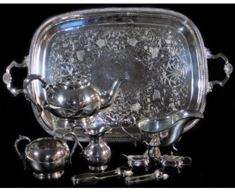 Various silver plated ware, an oval tea tray with shaped shell capped handles, 61cm wide, large sauce boat, bullet shaped tea