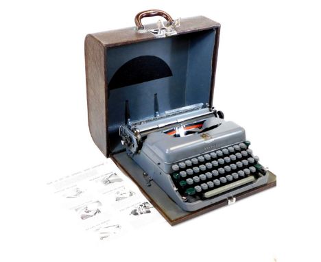 A vintage 20thC Imperial Good Companion No.5 portable typewriter, in grey, with grey and green keys, in a partially stitched 