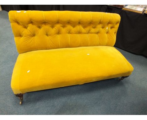 A mahogany framed button back low sofa