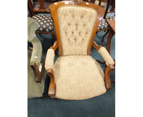 A late Victorian mahogany framed upholstered button back open armchair.