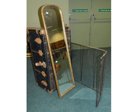 A early/mid 20th century tin-bound steamer trunk together with a mesh fire guard and a tall bevelled edge gold framed hall mi