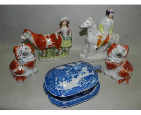 A group of 19th century Staffordshire porcelain to include a cow group, an equestrian figure possibly a jockey, a pair of Sta