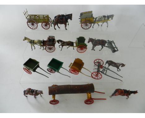 A group of 10 horse drawn carts and implements in lead by Britains, Charbens and others. Items including a hay rake, roller, 