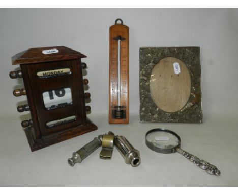 Works of art to include an early 20th century oak desk rotary calendar, a Chinese style tinned copper relief moulded picture 