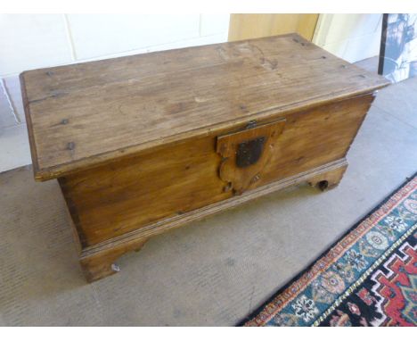An antique pine trunk with original fittings