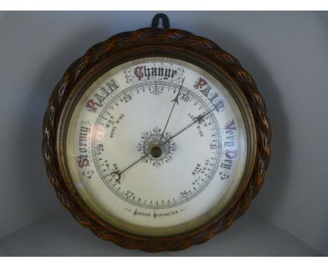 An oak Aneroid barometer with carved rope decoration