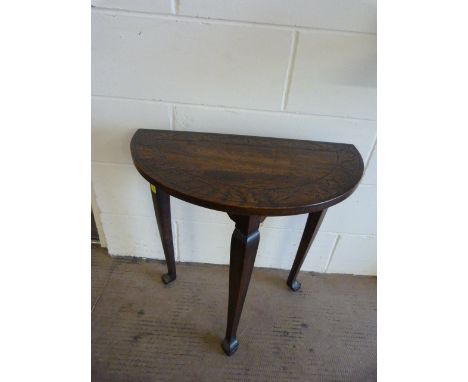 An Oak Half moon table with carved decoration to top