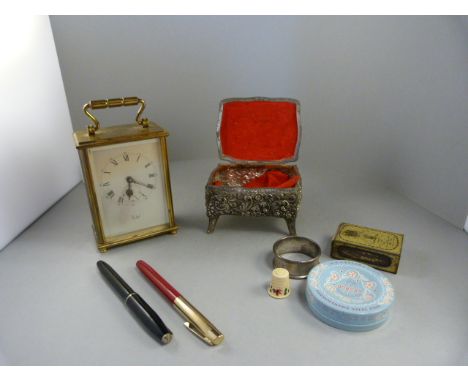 A Brass Carriage clock with Swiss Movement, pewter pot containing hallmarked silver napkin ring, pens, thimble etc