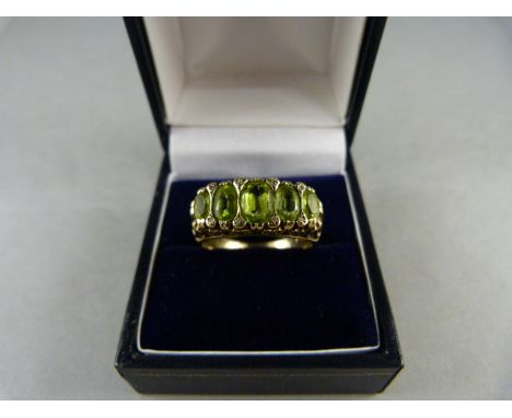 A 9ct Yellow Gold ring set with oval Peridot stones and eight diamond chips, table facets a little rubbed. Size T(UK) 9.5(USA