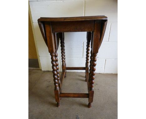 A small oak dropleaf table on Barley Twist legs