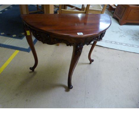 A reproduction mahogany half moon table on Concave legs