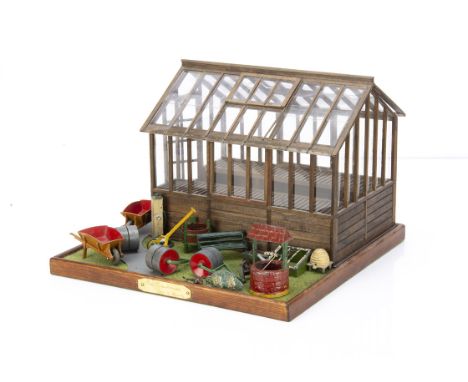 A recent dolls' house miniature green house, by K Clark, wooden with perspex glass on grassy base --12¼in. (31cm.) wide; and 