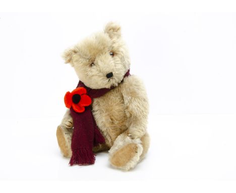 A post-war Chiltern Hugmee teddy bear,  with blonde mohair, orange and black plastic eyes, black stitched nose, mouth and cla