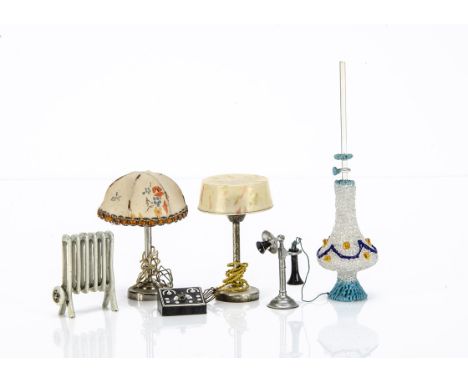 Dolls' house technology,  a German cast-metal radiator, probably Plank --2in. (5cm.) high; two electric-lit table lamps with 