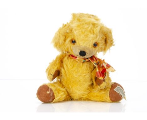 A small Merrythought Cheeky teddy bear 1960s,  with shaggy golden mohair/mix plush, orange and black glass eyes, inset velvet