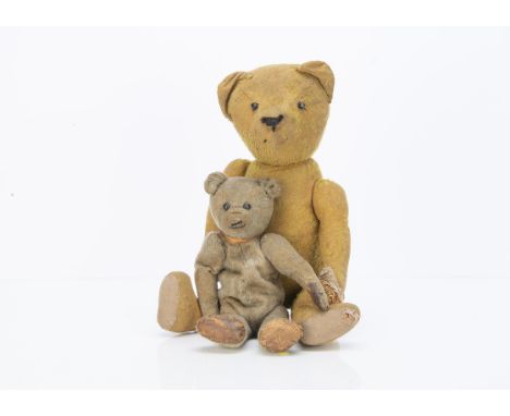 A small German teddy bear 1910-1920, with blonde mohair, black boot button eyes, pronounced muzzle, black stitched nose, mout