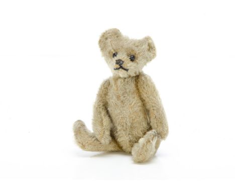 An early Steiff small teddy bear,   with light golden mohair, black boot button eyes, pronounced clipped muzzle, black stitch