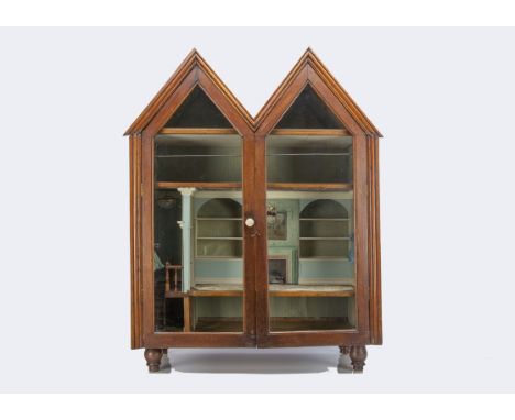 An interesting 19th Century mahogany cabinet dolls' house, with two gables, two side windows, glazed doors with bone handle a