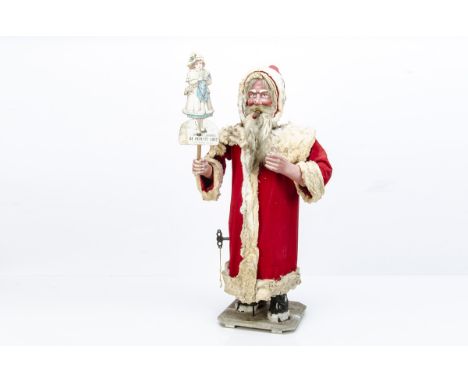 A large German clockwork window display nodding Father Christmas automaton, with composition head and hands, blue painted eye