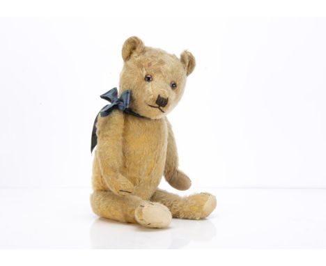 A 1930s Chiltern-type teddy bear,  with golden mohair, clear and black glass eyes with brown painted backs, pronounced muzzle