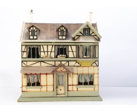 A rare Christian Hacker dolls' house No 493, painted cream with brown and black timber work, central front door, paper tiled 