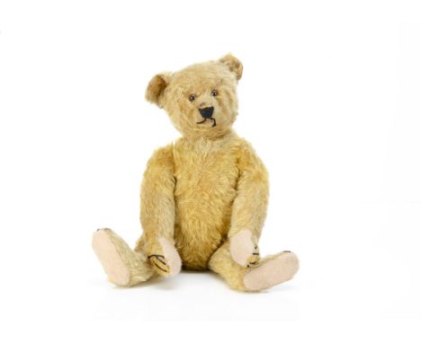 A 1920s Steiff teddy bear,  with golden mohair, clear and black glass eyes with brown backs, pronounced muzzle, black restitc