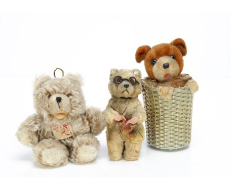 A Reuge (Swiss) musical teddy bear cot toy,  unjointed Zotty type with brown and black glass eyes, large label on front and p