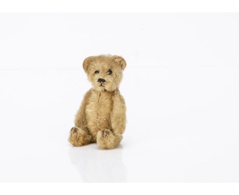 A Schuco teddy bear perfume bottle, with golden mohair, black boot button eyes, black stitched nose and mouth, metal framed j