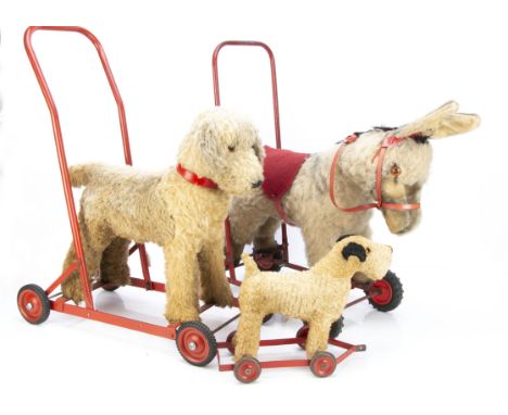 Three British post-war wheeled animals, a Chiltern dog on wheels with red painted tubular metal wheeled frame and label on un